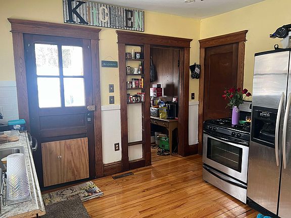 Kitchen and pantry. Left door leads to the backyard, middle door is pantry, and right door leads to the basement.