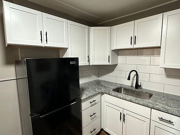 White cabinets with black appliances at University Court.