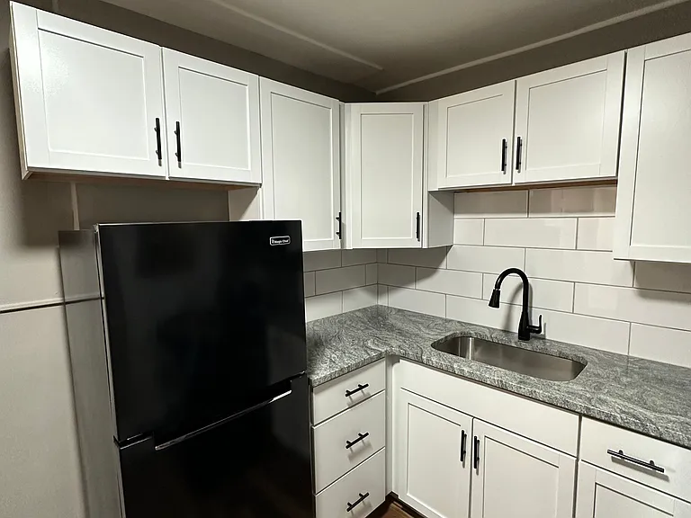 White cabinets with black appliances at University Court.