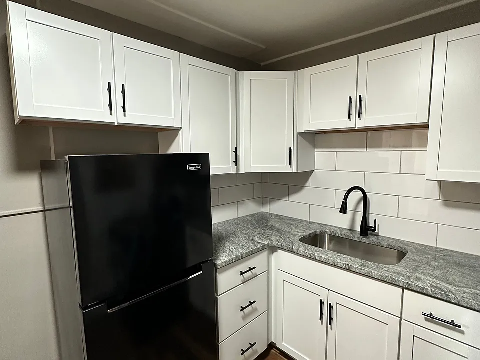 White cabinets with black appliances at University Court.