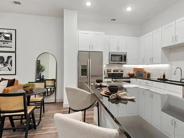 Kitchen Area Featuring Dining Table, Fridge, and Island Seating