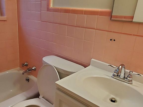 Ultra cool pink and white bathroom with all new amenities.