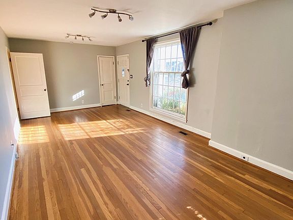 Large living room with tons of natural light, plus updated track lighting fixtures