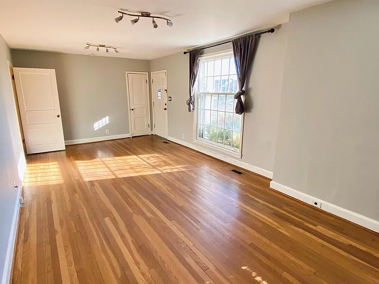 Large living room with tons of natural light, plus updated track lighting fixtures