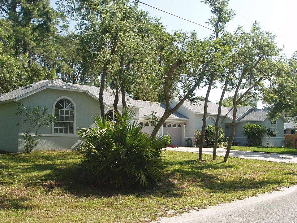 Attractive contemporary CBS 1/2 duplex surrounded by shade trees for lots of privacy.