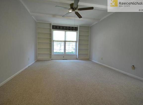 Living Room with Great Built In Shelving and Ceiling Fan!