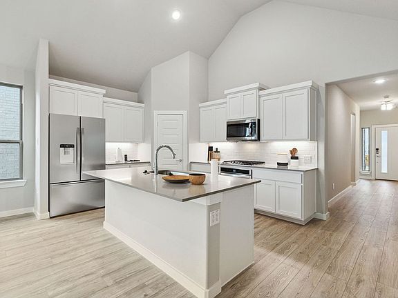 Kitchen in the Claret home plan by Trophy Signature Homes - REPRESENTATIVE PHOTO