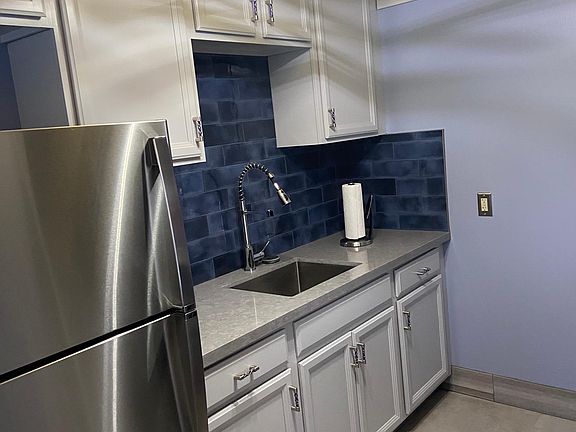Totally remodeled kitchen, with stainless steel appliances, stove and refrigerator.