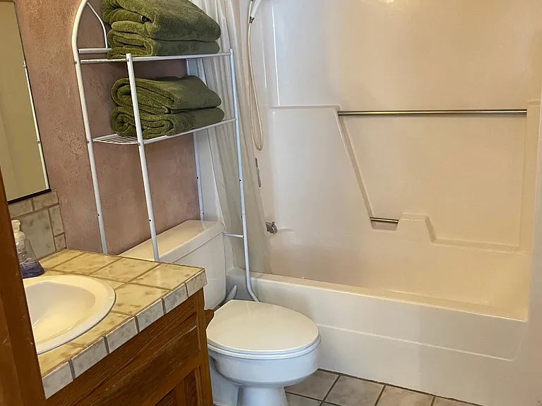 Bathroom in second bedroom. Single sink, tub and shower.