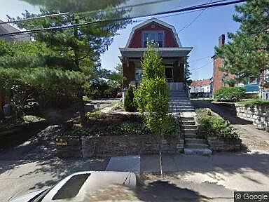 Street view with driveway on the left. Three spots come with the house, and others are rented to neighbors.