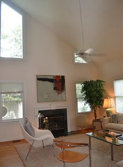 BIG family room with ceiling fan, great windows and a fireplace.