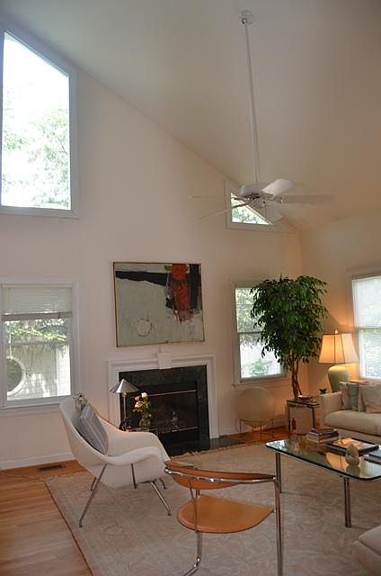 BIG family room with ceiling fan, great windows and a fireplace.