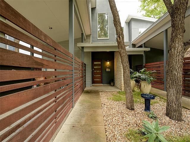 Front entrance with modern carport / garage space.