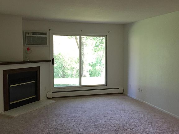 living room with new carpet and fireplace