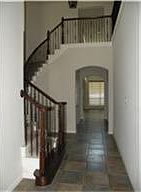 Soaring Entry with Wrought Iron Staircase.