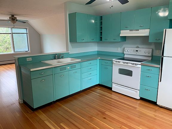 Authentic retro kitchen overlooking living area. All newly finished hardwood floors.