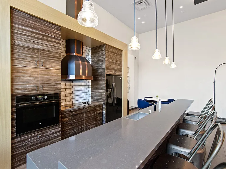 Common Area with Kitchen and Seating at Aventine Apartments in Hercules, CA 94547