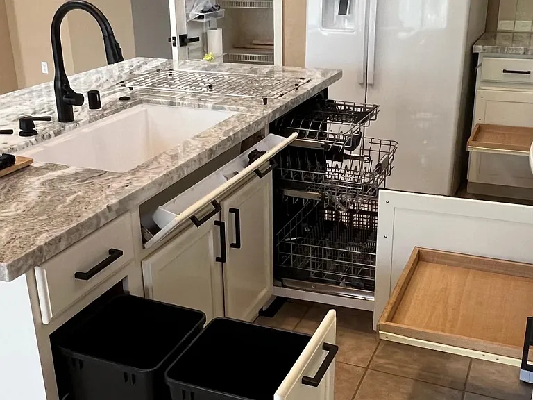 kitchen showing trash can pull out, sink storage tip out, 3 rack self clean dishwasher, lower cabinet slide out drawers, pantry storage door rack