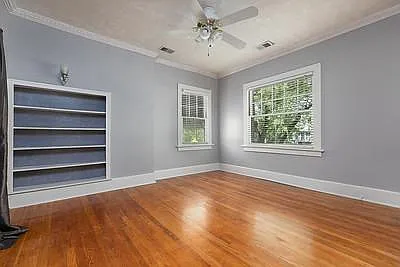 Master Bedroom with his and hers closets. Built In Book shelf. Ceiling Fan. 3 Original Antique wall sconce lights. Windows are original 1905 "Rolled Glass".