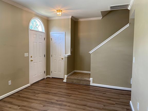 Living room facing front door and stairwell