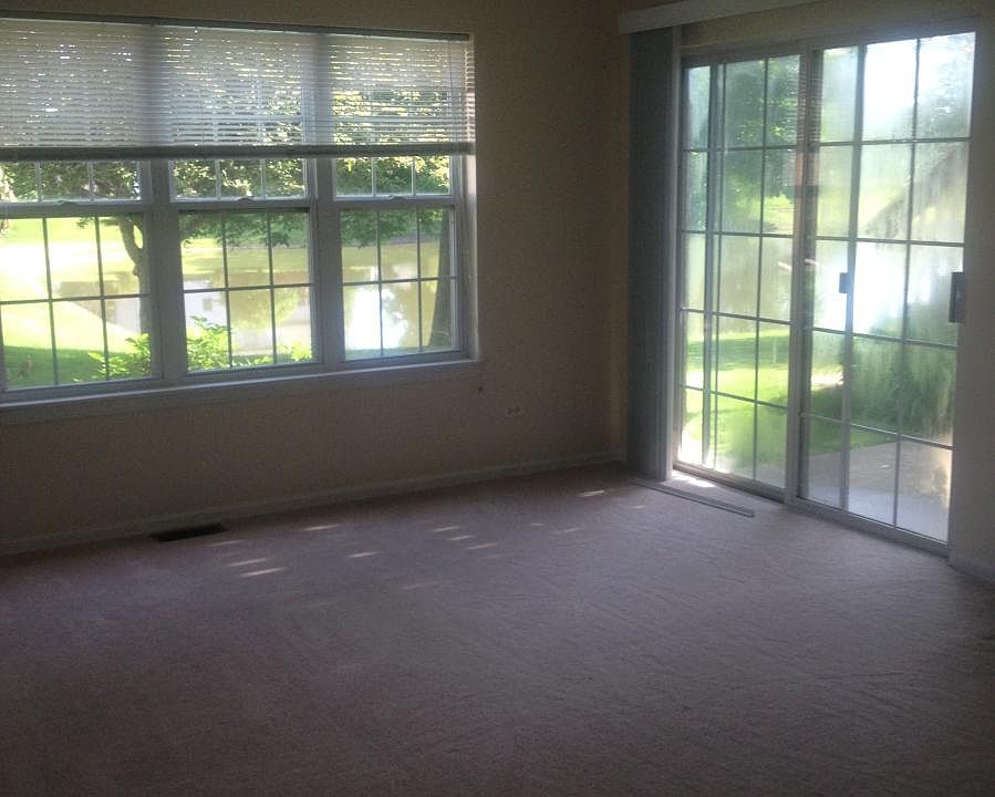 Living room with view of pond and patio
