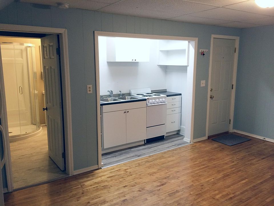 Kitchenette with 33" stainless double sink, stove, and plenty of shelving/drawers.