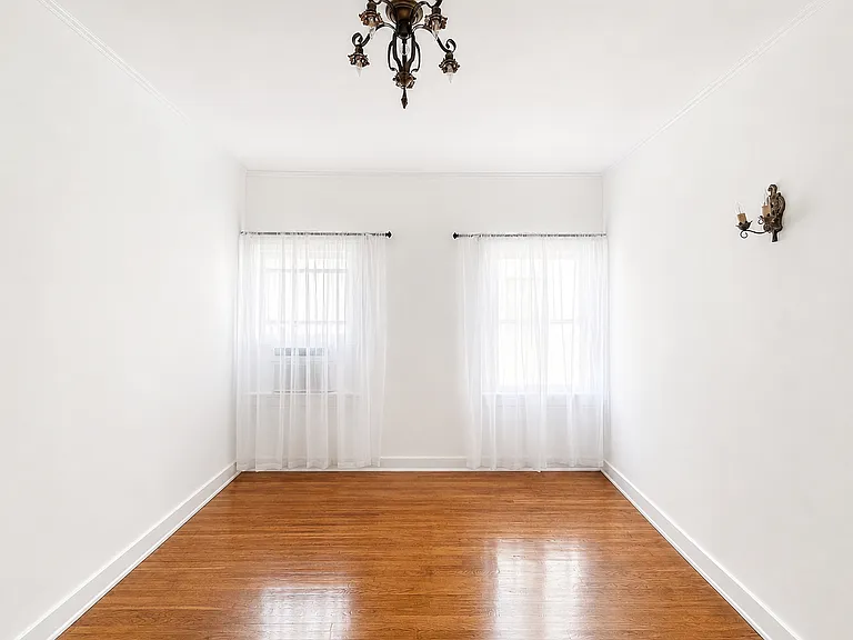 Updated bedroom picture (July 15, 2026) with new A/C, new 1920's chandelier and window sheers.