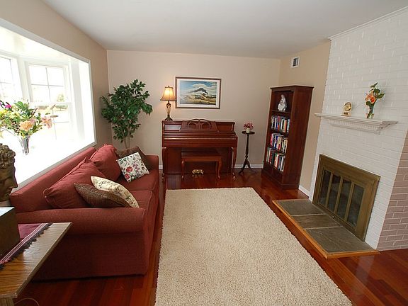 Formal Living Room with wood burning fireplace and Brazillian Cherry Hardwood 