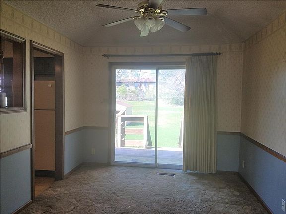 Formal Dining with Vaulted Ceiling, Sliding glass door, & Ceiling fan