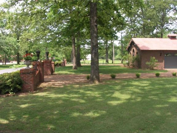 "The property features 2 brick entry ways and a drive thru garage."