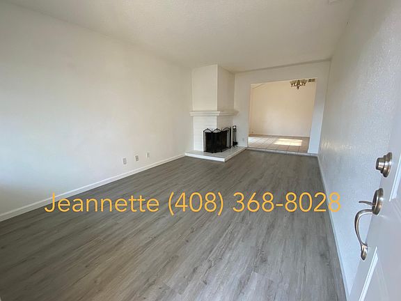 Entrance into living room with fireplace and brand-new vinyl flooring