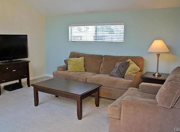 Spacious and bright living room with sliding doors to a deck.