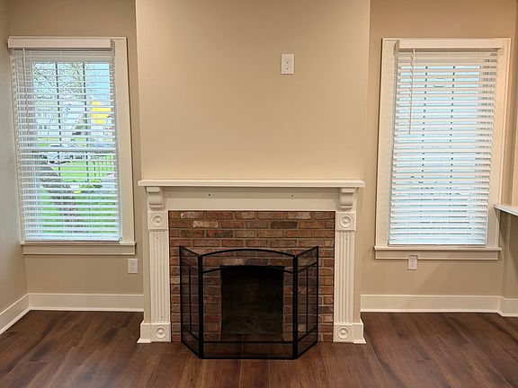 Custom mantel and brick surround fireplace (non-working) is centerpiece of Great Room.
