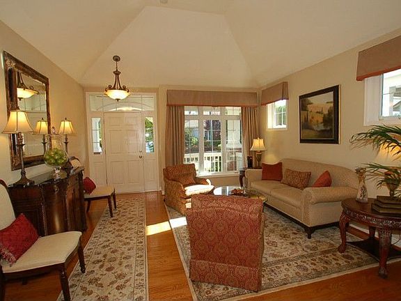 Formal Living Room with cathedral ceiling, extensive oak hardwood floors, white painted millwork and