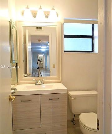 Second Bathroom with new vanity, mirror and lighting fixture.