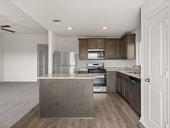 The kitchen has sprawling granite countertops.
