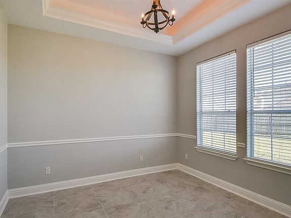 With cove lighting and a view of the expansive front lawn, no matter how you choose to utilize this space, this sun-filled space is cozy.