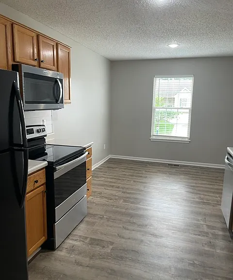 View of galley kitchen with new built in microwave and new smooth top stove