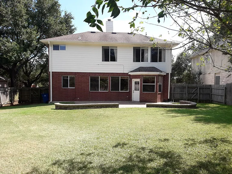 Large private backyard with paver patio