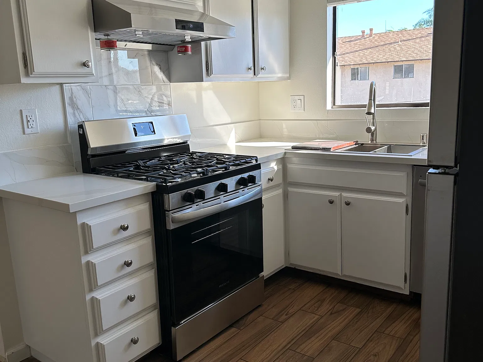 Kitchen with new stove, sink, dishwasher, refrigerator