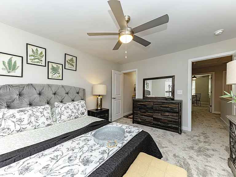 Cozy bedroom with carpet & ceiling fan