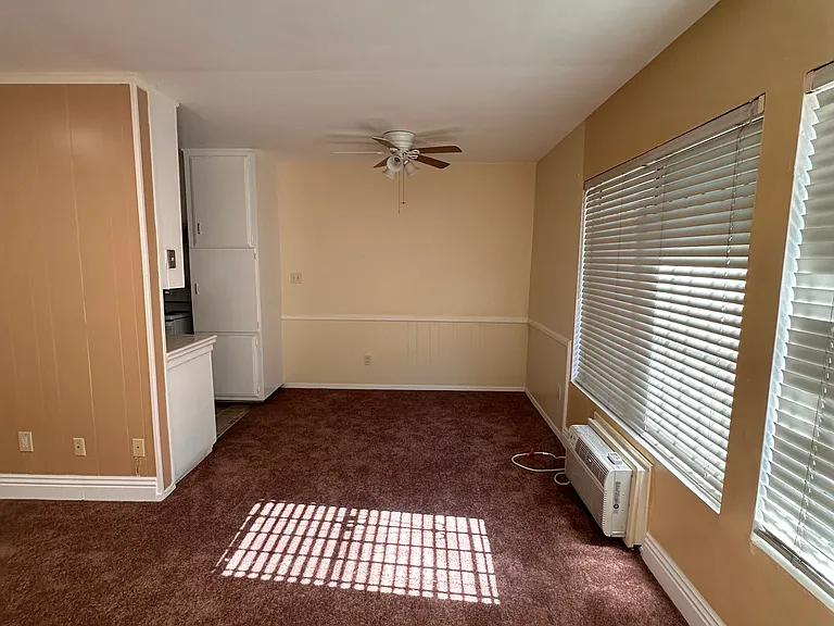 Dining Room w/ ceiling fan and air conditioner.
