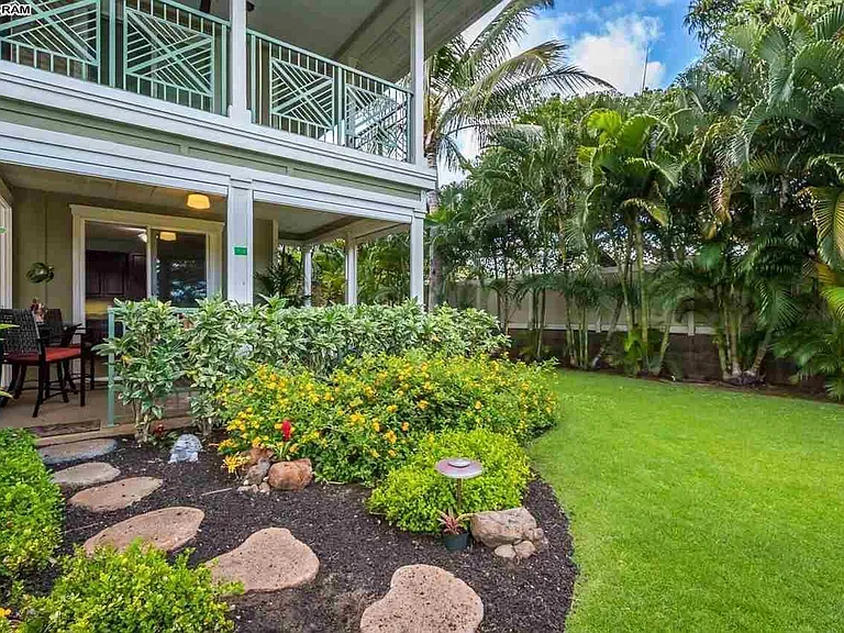 Opening from our lanai onto the backyard gardens. Planters are ours and have succulents. Room for many more plantings.
