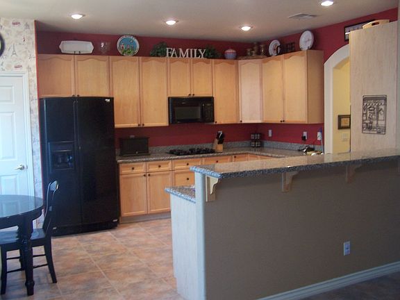 Your new kitchen has upgraded cabinets, granite countertops, built-ins,   bar!