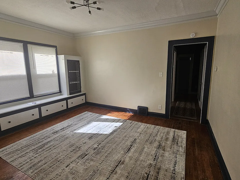 Freshly-painted dining room with new modern light fixture and blinds