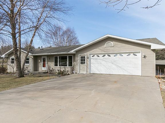 Paved drive leading to the large detached heated workshop.