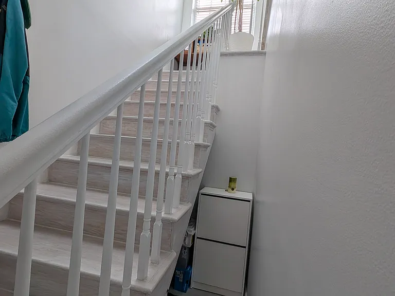 Shoe storage niche below entrance staircase