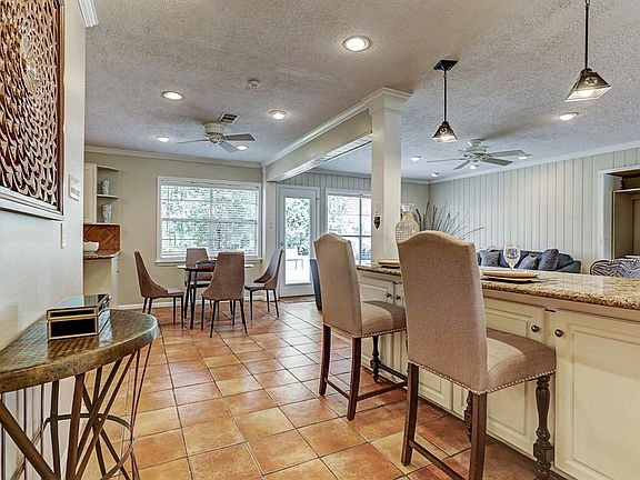 From the Kitchen you can see the Serving area by the Dining Area with Pendant Lighting, the Family Room and part of the Living room