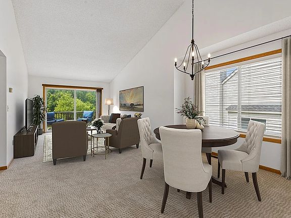 Living Room and dining area. Lots of natural light with high ceilings and view deck.