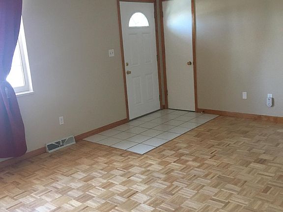 Living Room main level with Birch wood floor. All new paint and floor refinished. Tile entry and closet. New windows.